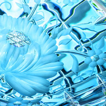 Detail of an azure blue crystal jardinière from the Sunrose collection. On the left, a large stylised flower with delicate petals and a glittering centre takes centre stage. Faceted lead crystal with floral engravings brilliantly reflects the light.
