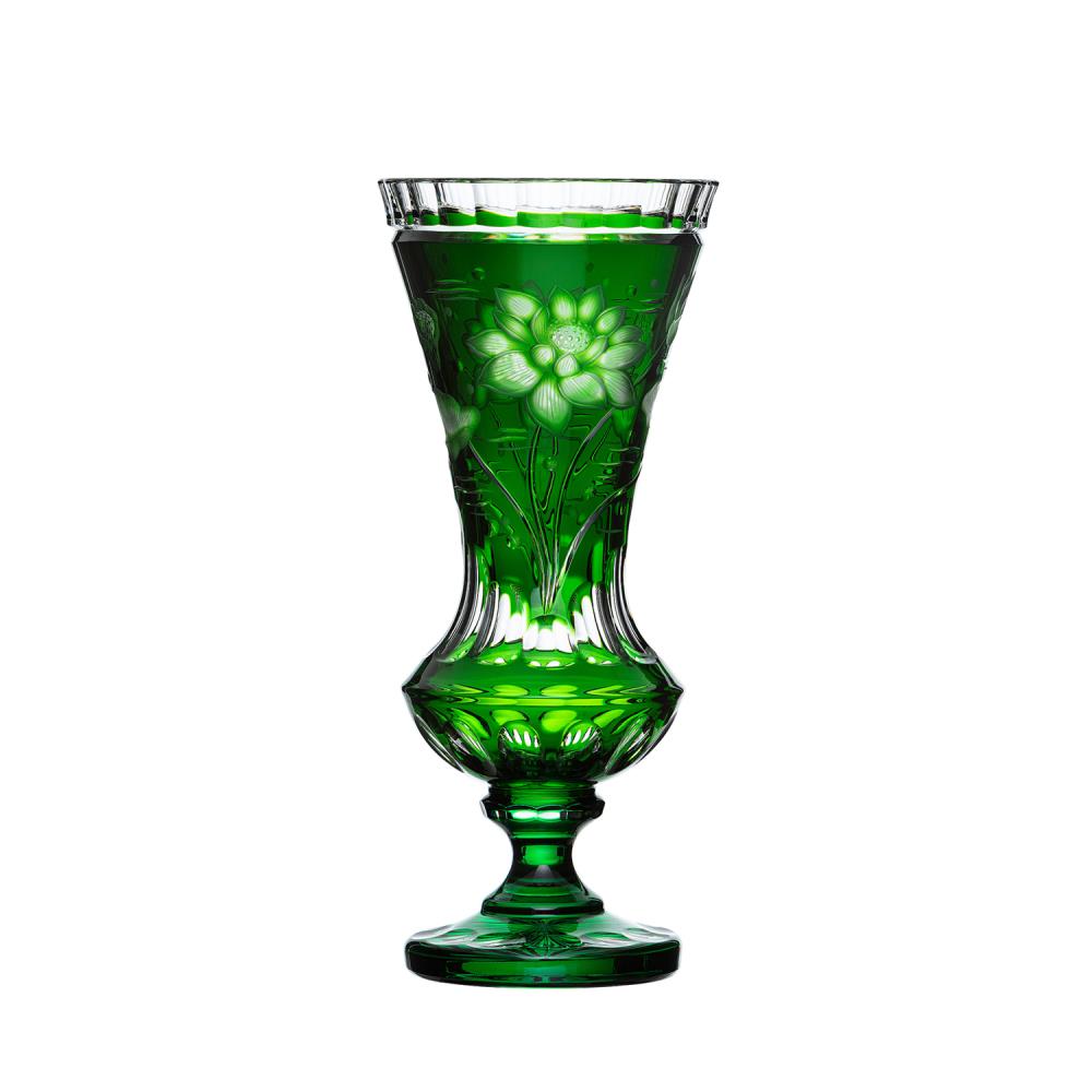 A tall, slender vase in emerald green crystal, featuring intricate, frosted engravings of lotus blossoms and leaves on the upper bowl. Slightly flared opening, curved body and sturdy round base.