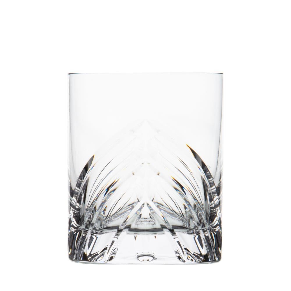 A heavy, clear crystal whisky glass, cut with an opulent, symmetrical pattern that tapers upwards from the thick base and is reminiscent of wings. Smooth edges at the top. Handcrafted, it sparkles with facets.