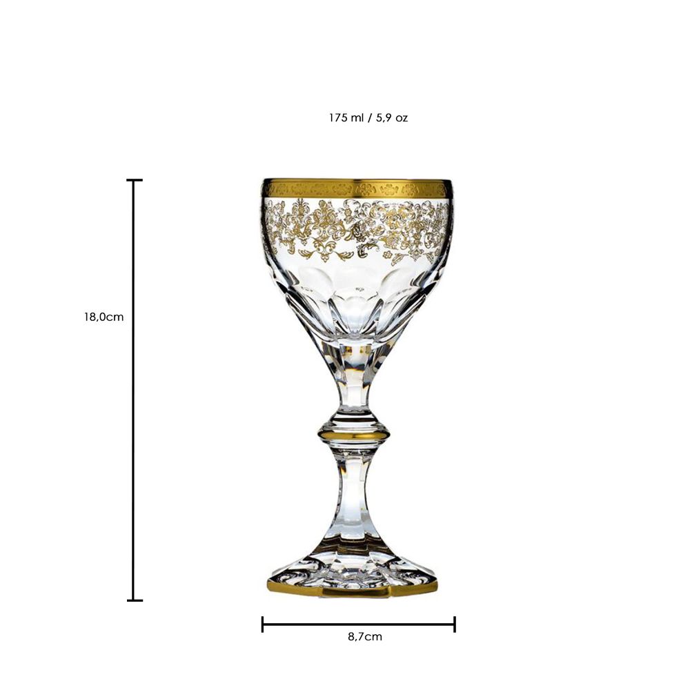 Elegant, clear crystal red wine glass (18 cm). Upper rim of the bowl features a detailed golden floral pattern. Bowl is faceted and cut. Slender stem with a golden ring; hexagonal base with a golden rim.