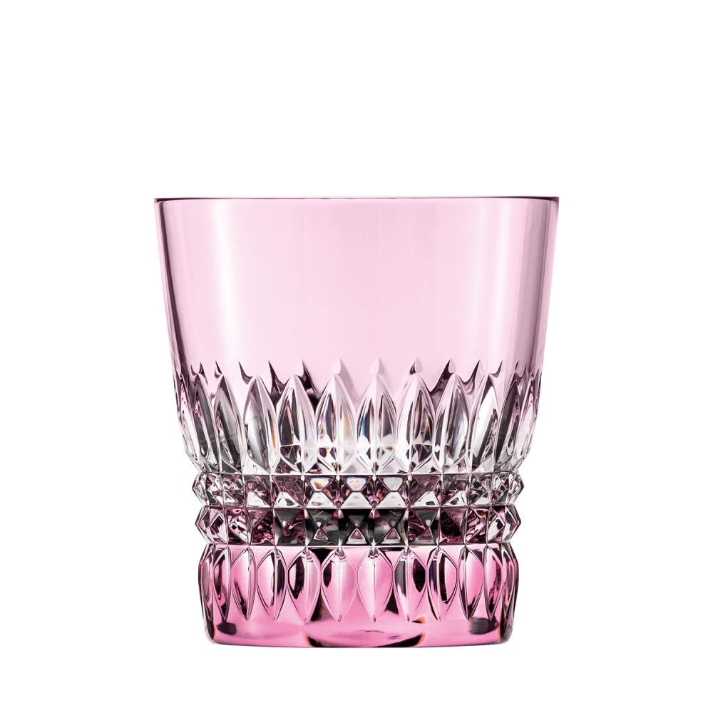 Pink crystal drinking glass (Empire tumbler) with a sturdy, thick base. Artfully decorated at the bottom with pointed, faceted cuts that brilliantly refract the light. Smooth at the top, with a soft pink sheen.