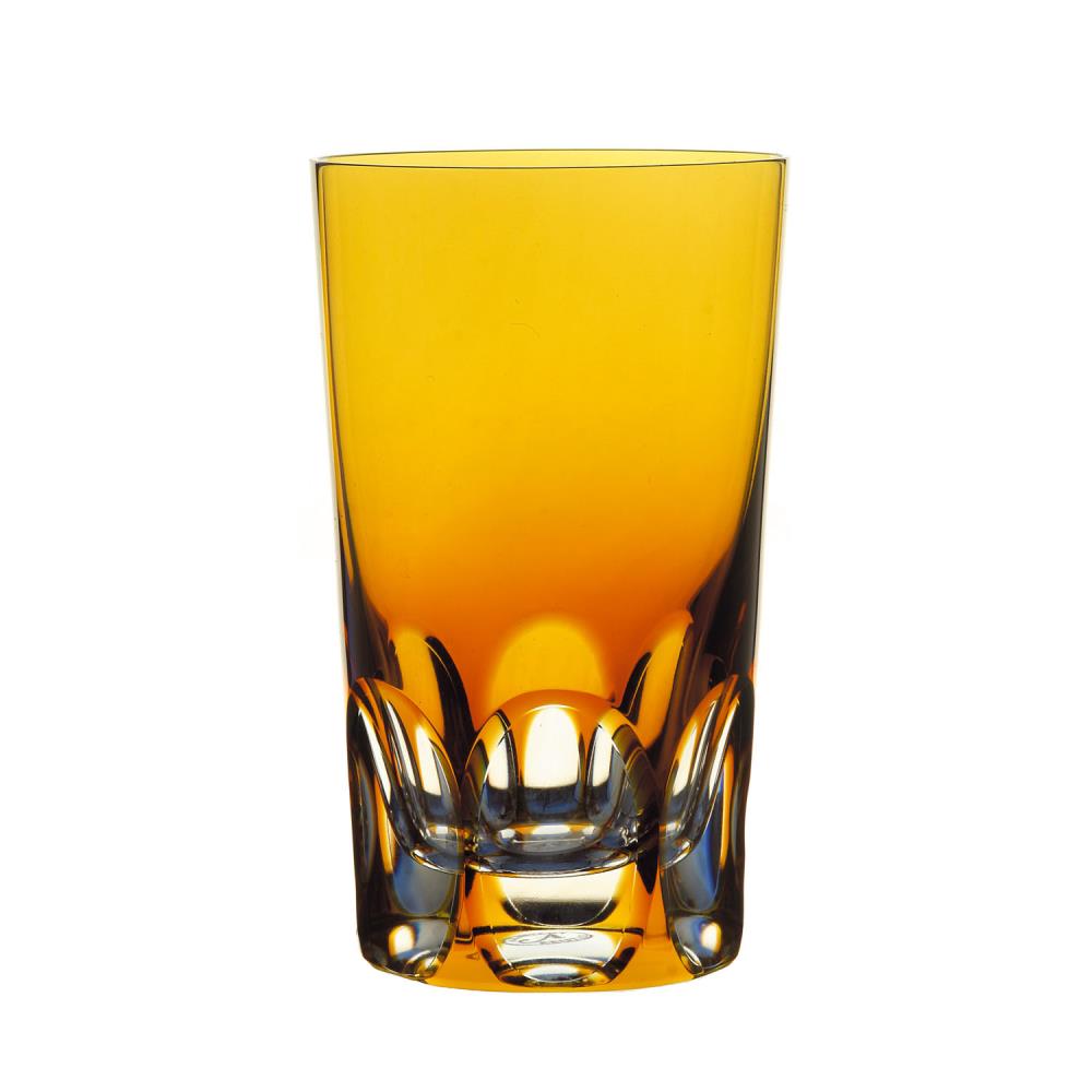 Tall long drink glass crafted from amber-coloured crystal. Warm amber at the top, becoming darker and richer towards the bottom. Sturdy base with six vertical, curved crystal facets that reflect light and create an elegant effect.