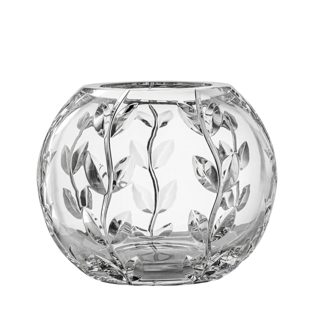 A round, transparent crystal vase featuring an artful cut pattern of stylised leaves and delicate stems. The clear glass surfaces reflect the light, whilst the cut leaf details lend an elegant, natural texture.