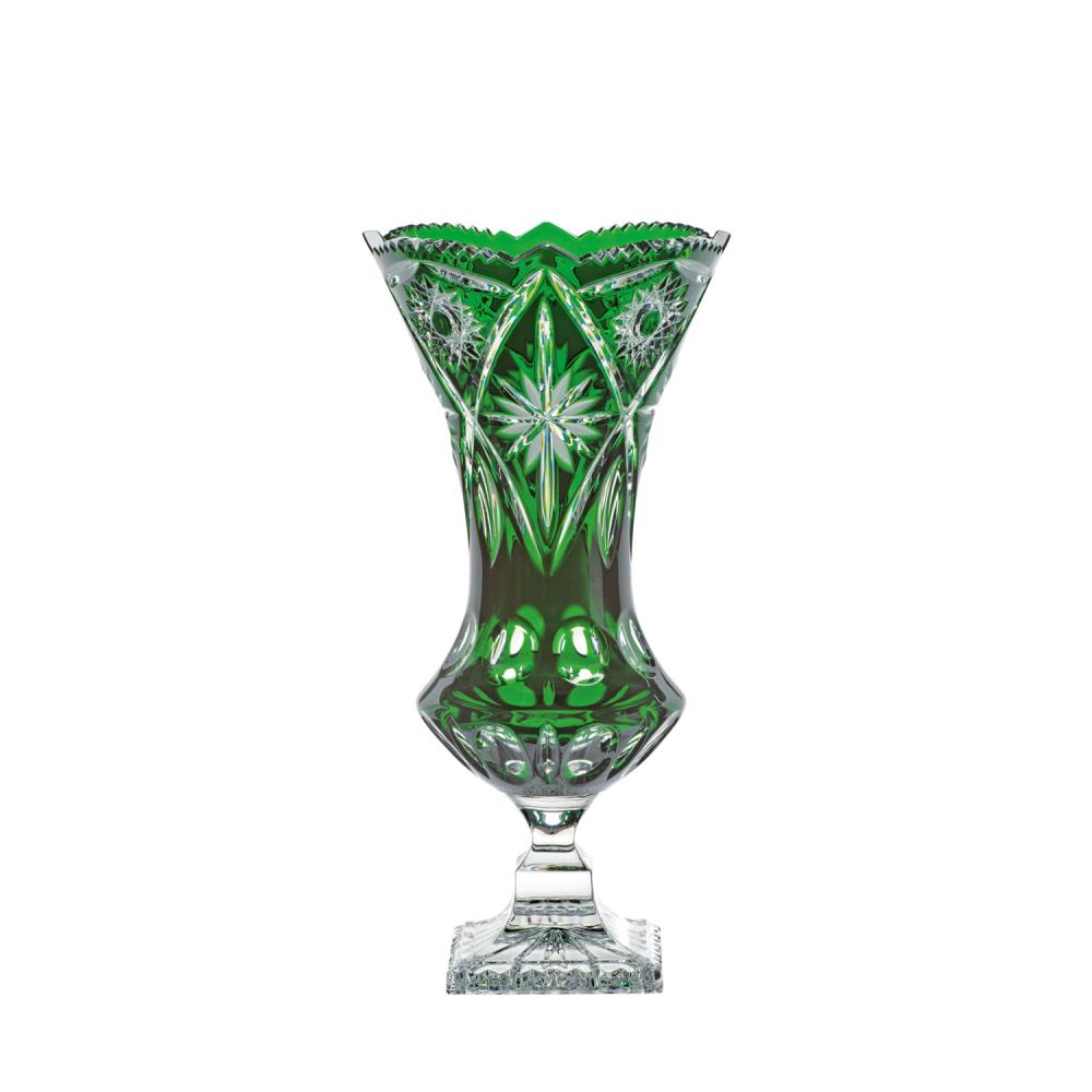 Tall, elegant crystal vase in deep emerald green with intricate cut patterns. Wavy rim, tapered body featuring ray- and leaf-like ornamentation. Bulbous foot on a clear, square base. 34 cm high.