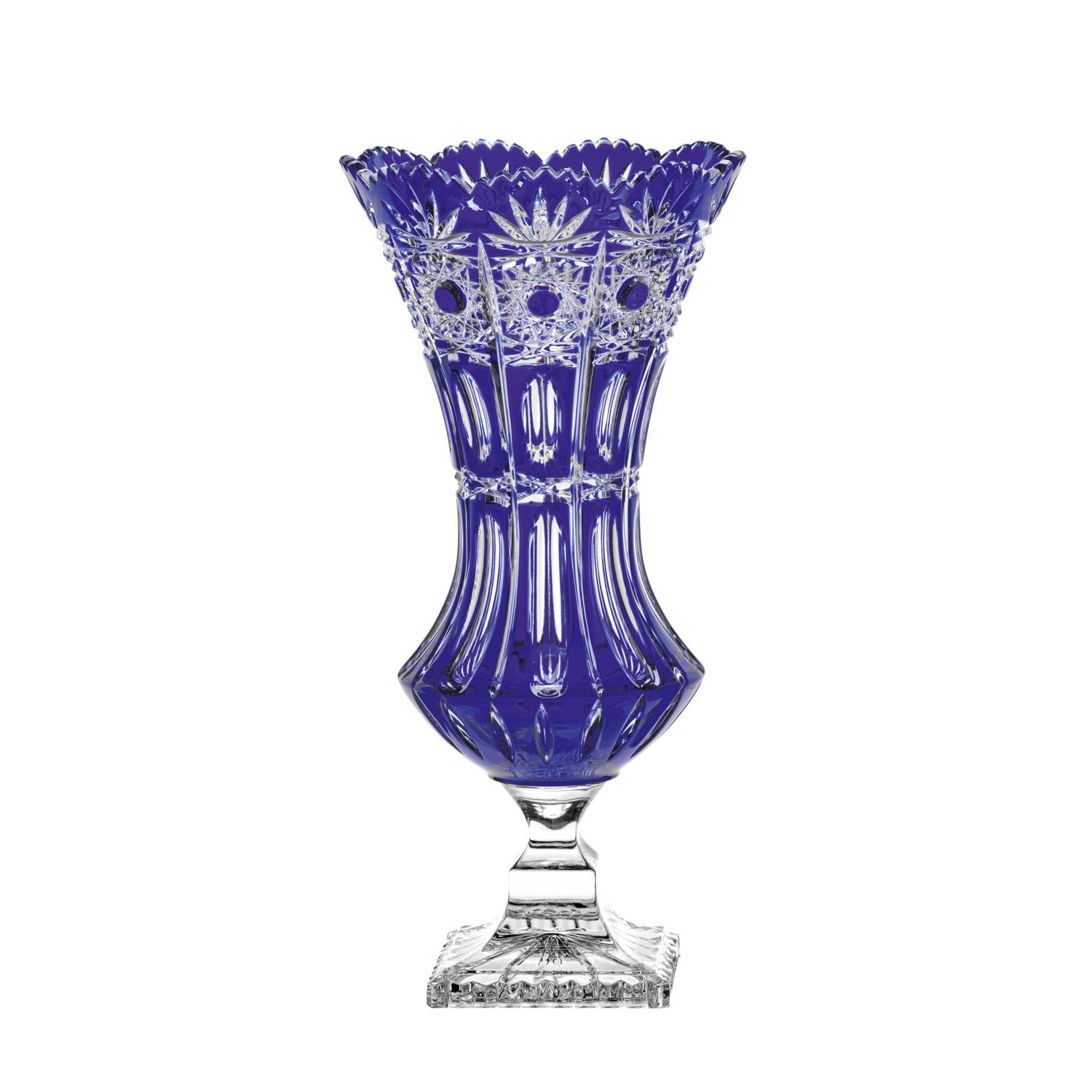 A tall, glossy vase crafted from cobalt blue crystal glass. Serrated rim with star-shaped and round facets. Body featuring vertical grooves and intricate cut patterns. Clear, square base. Dresden crystal vase (34 cm).